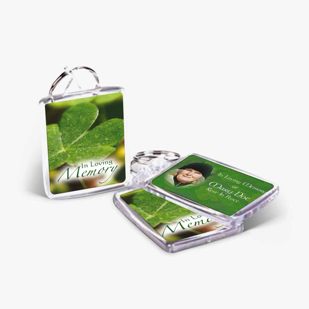 a key chain with a picture of a shamrock and a photo of a person