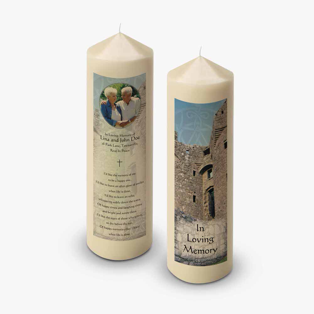 two candles with pictures of a castle and a woman