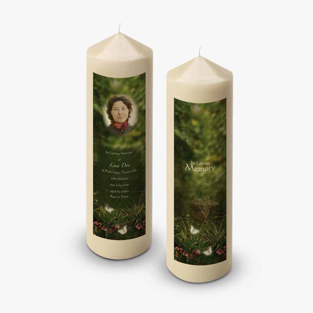 two candles with a photo of a woman in the forest