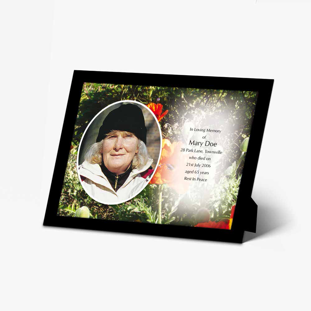 a memorial card with a photo of a woman in a field