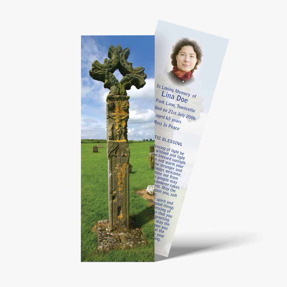 a bookmark with a cross on it and a picture of a person