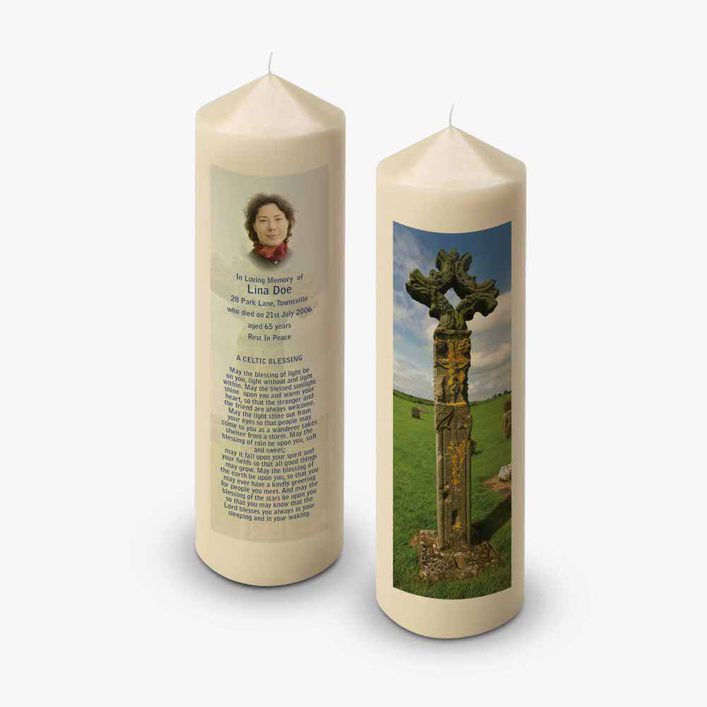 a candle with a picture of a cross and a poem