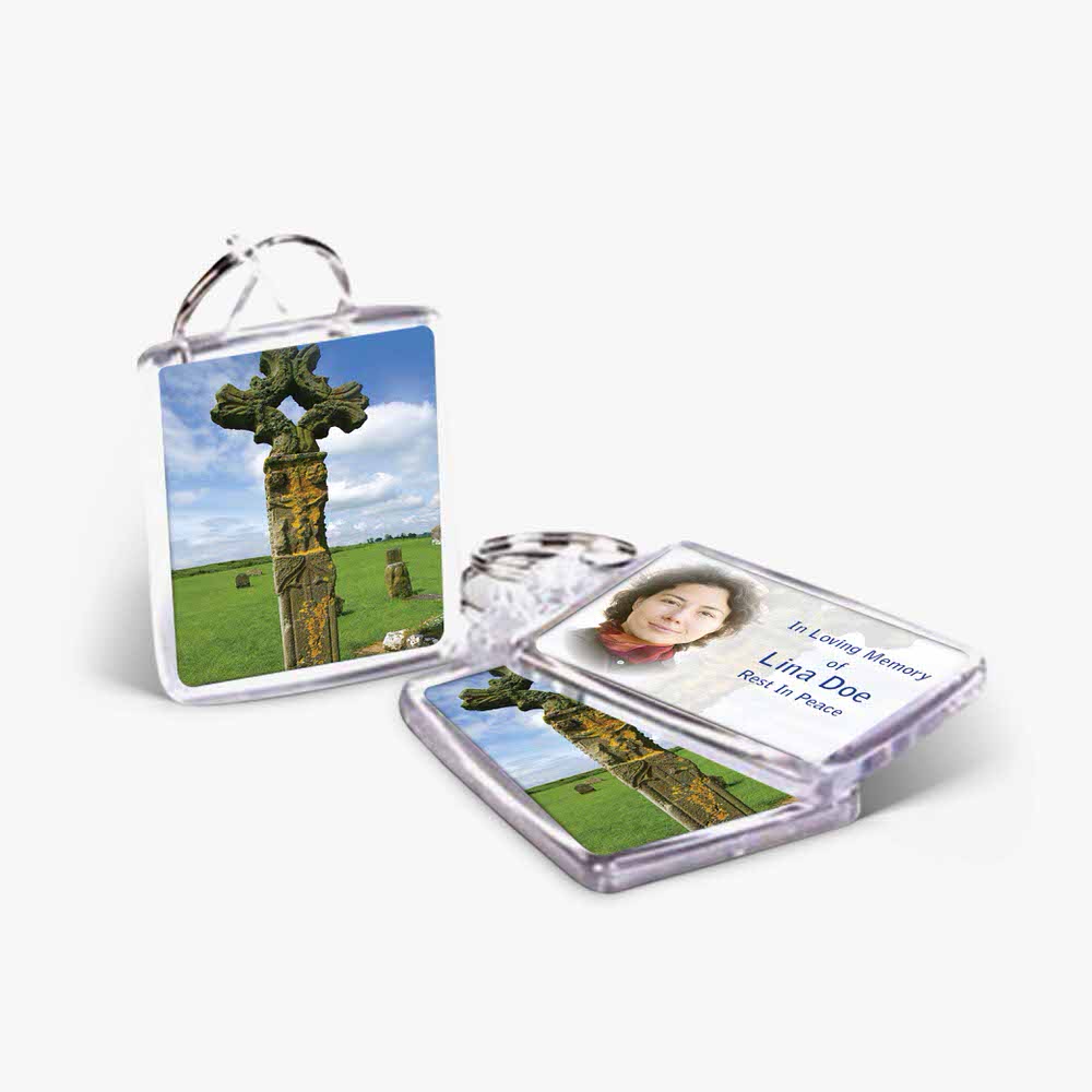 a photo card and a key chain with a cross on it