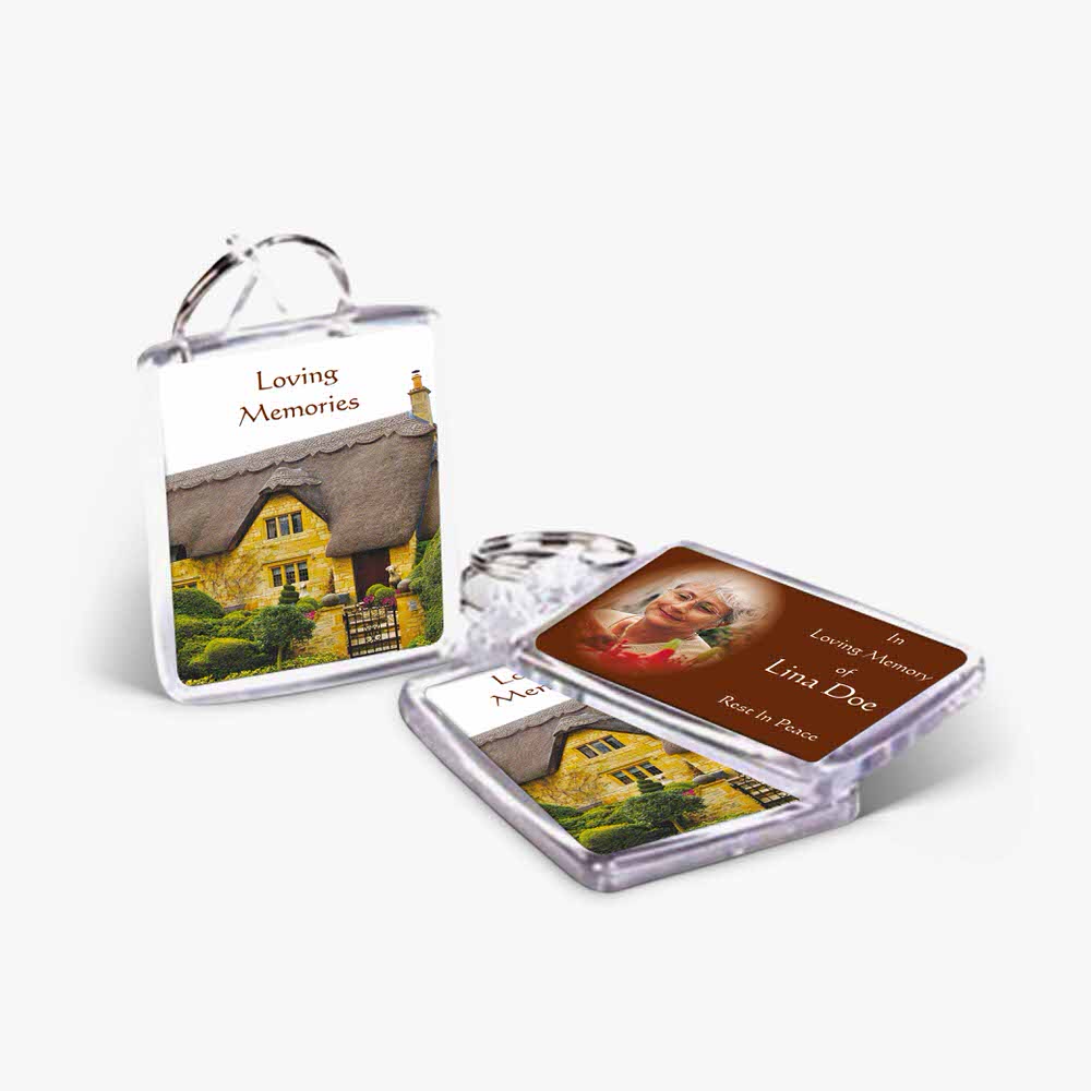 a keyring with a picture of a house and a card