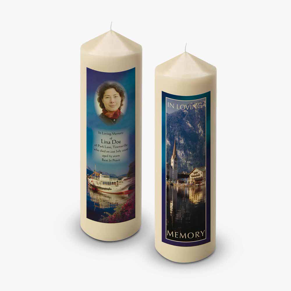 two candles with pictures of a lake and a boat