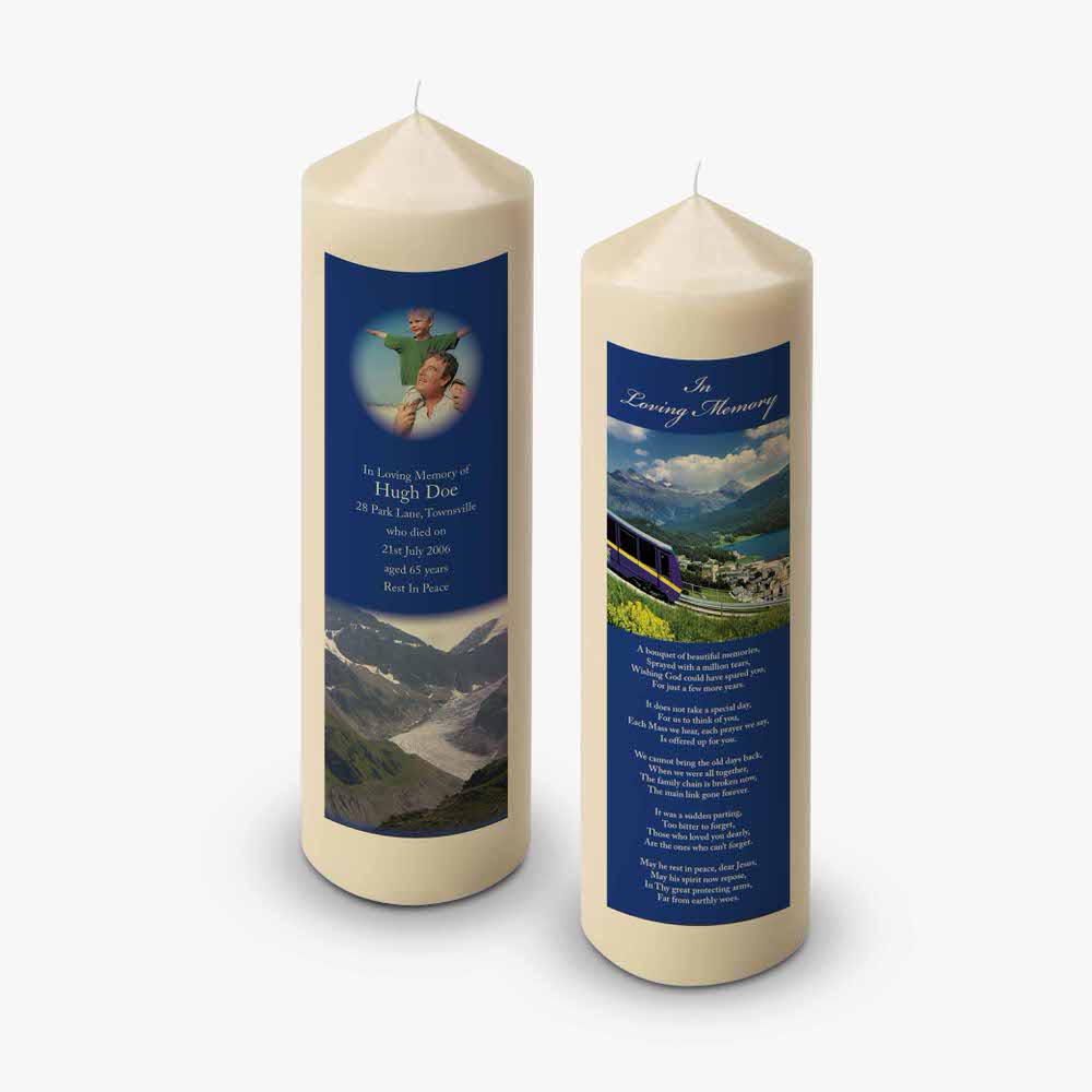 two candles with a picture of a mountain and a lake