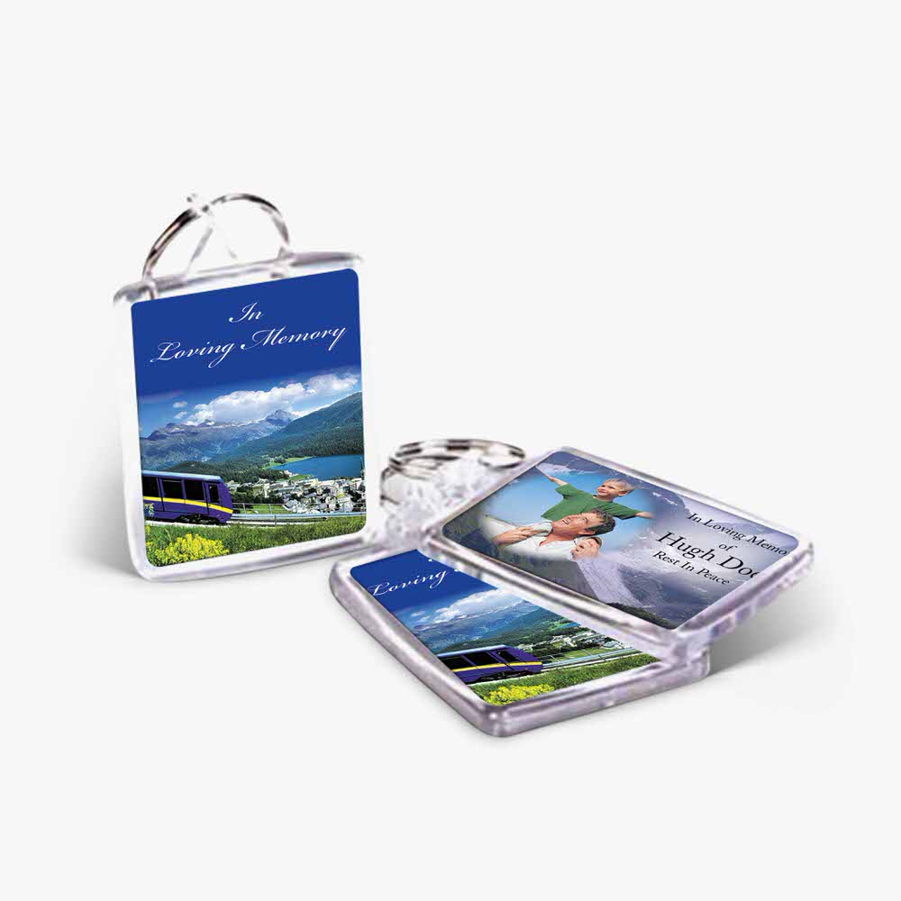 a keychain with a photo of a train and a photo of a mountain