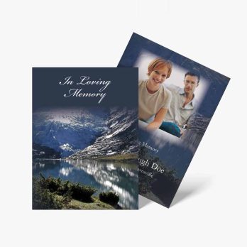 a funeral card with a photo of a couple on a mountain