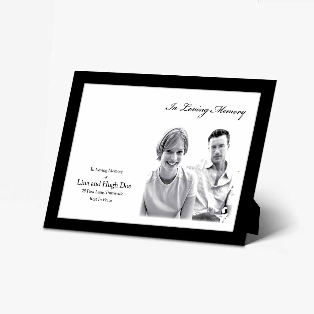 a black and white photo frame with a couple sitting on a couch