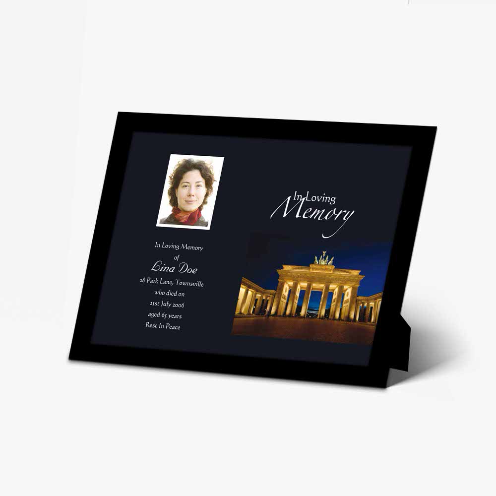 a memorial photo frame with a photo of a person in front of the brandenburg gate