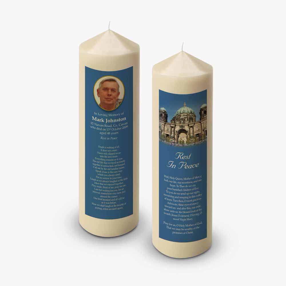 two candles with a picture of the cathedral