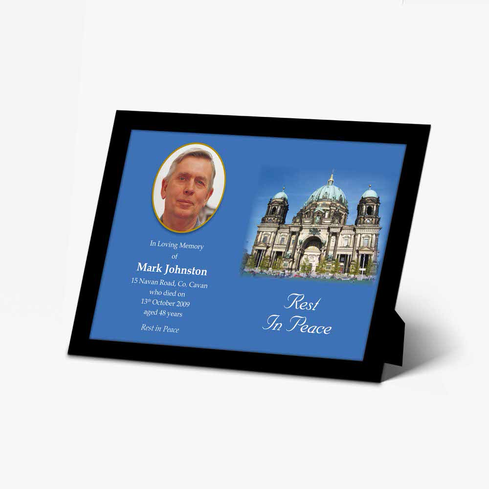 a framed photo of a church with a blue background and a white border