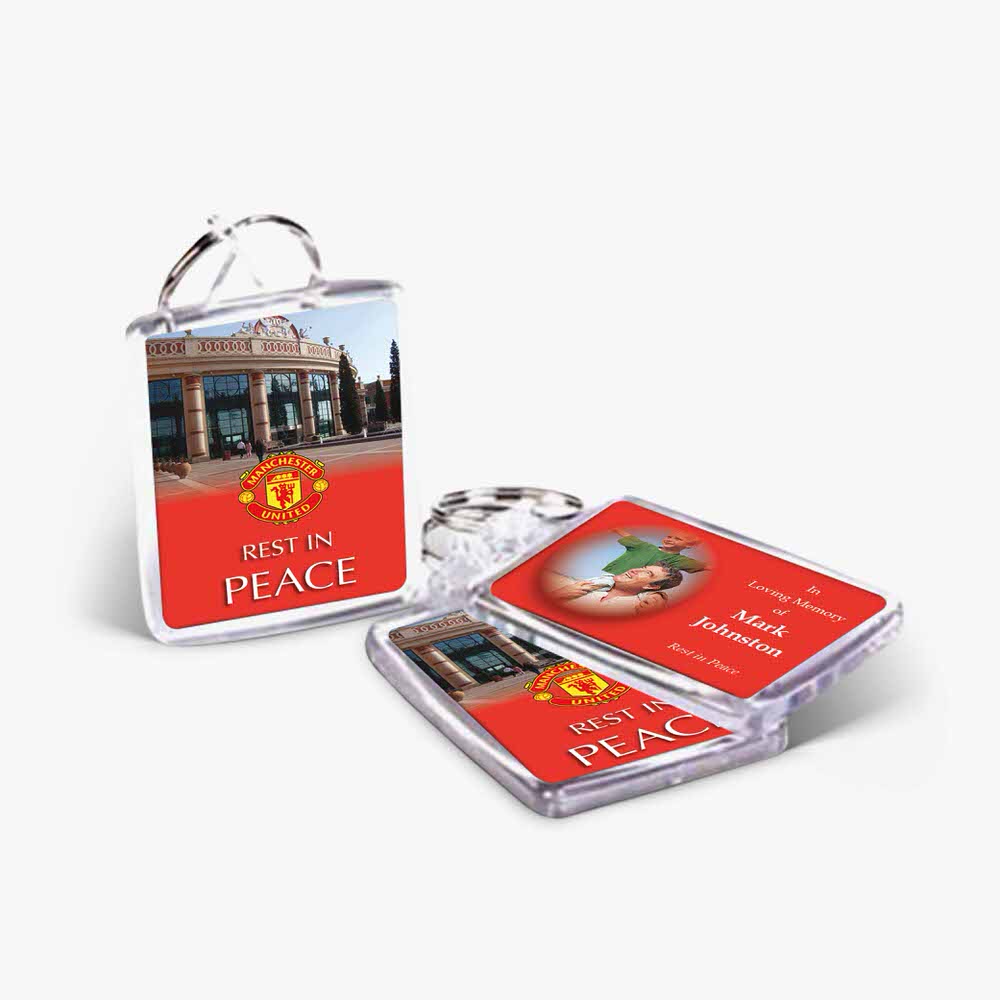 a keyring with a picture of a building and a sign that says peace in the background