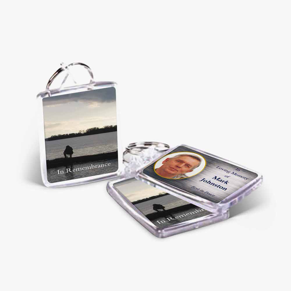 a clear keychain with a photo of a man on it