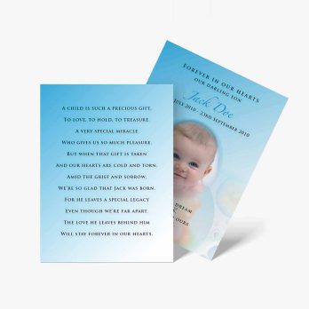 a blue baptism card with a baby's face on it