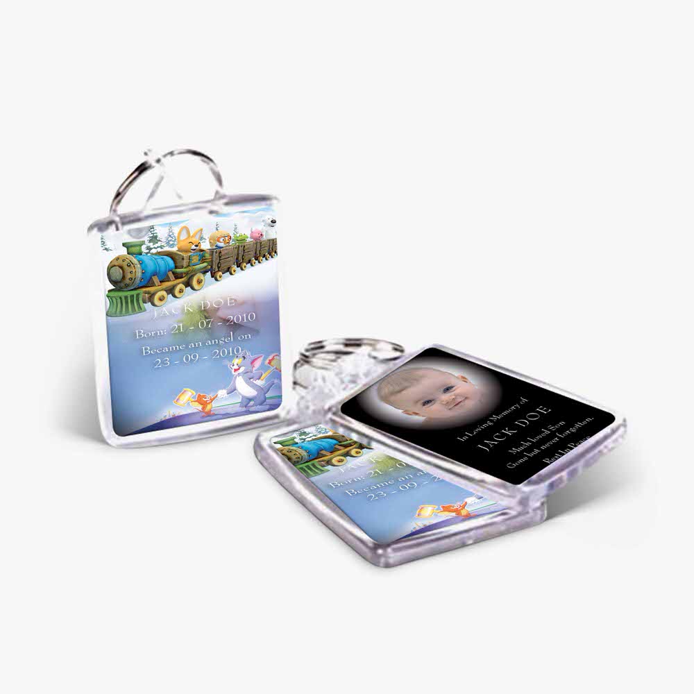 a baby's photo is on a key chain