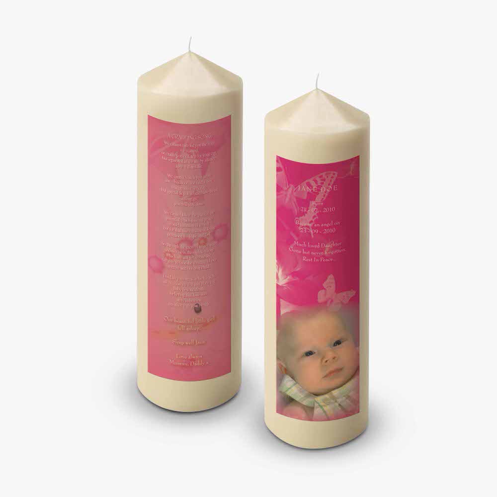a pink candle with a baby's photo on it
