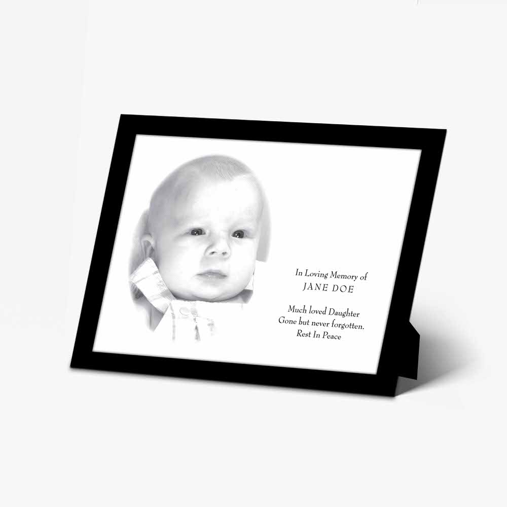 a black and white photo of a baby with a white background