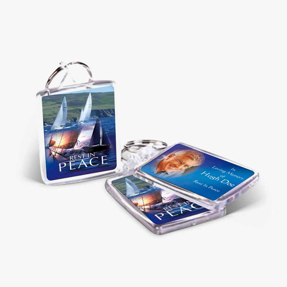 a key chain with a picture of a sailboat on it