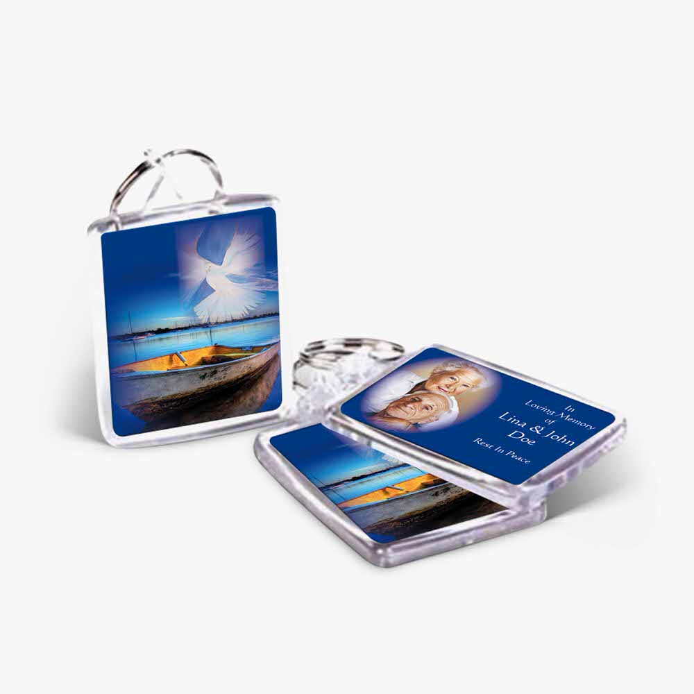 two key chains with a photo of a boat and a photo of a person