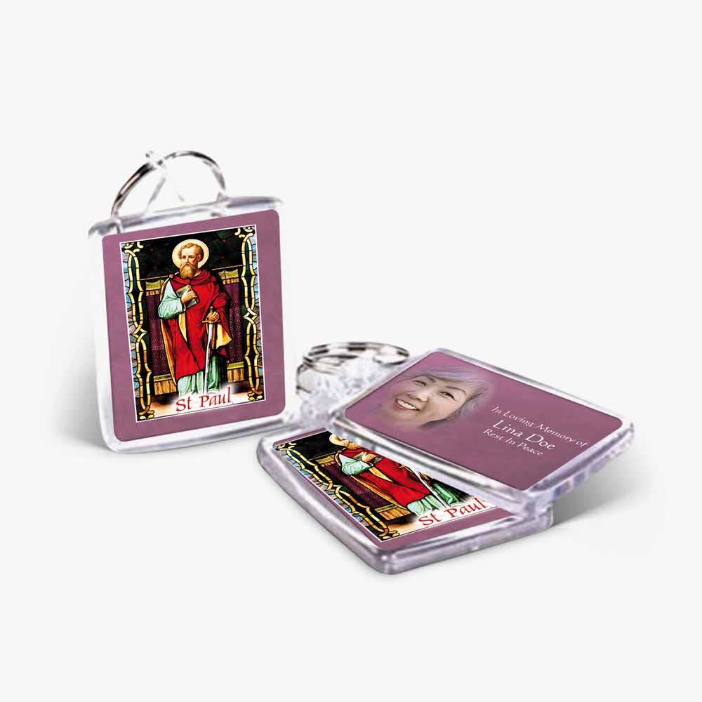 a key chain with a picture of a saint and a picture of a woman