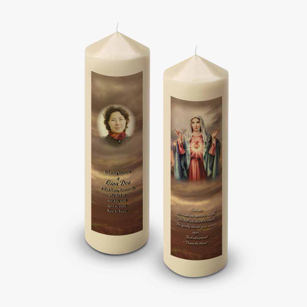 two candles with a picture of mary and jesus