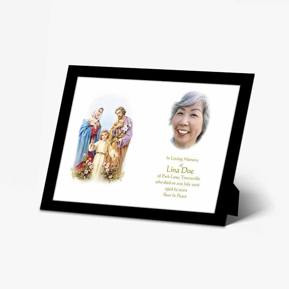 a framed photo of the holy family with a prayer card