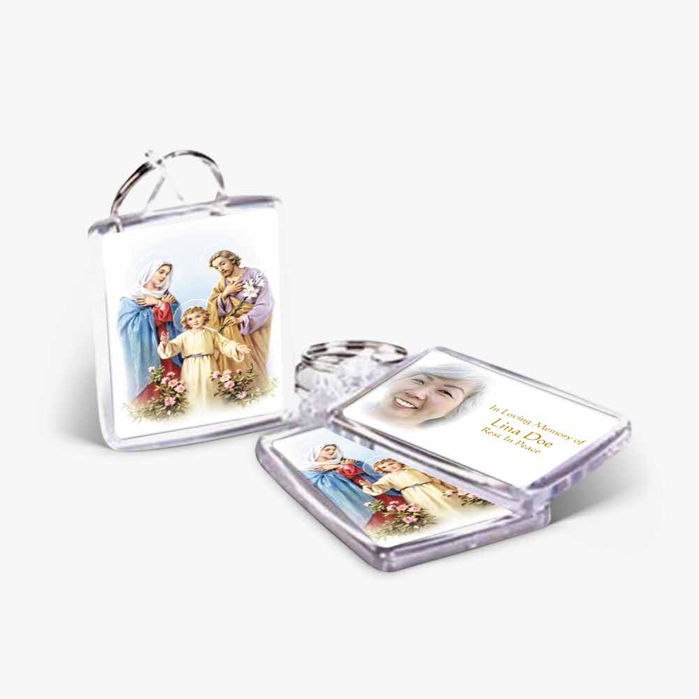 a small key chain with a picture of the holy family