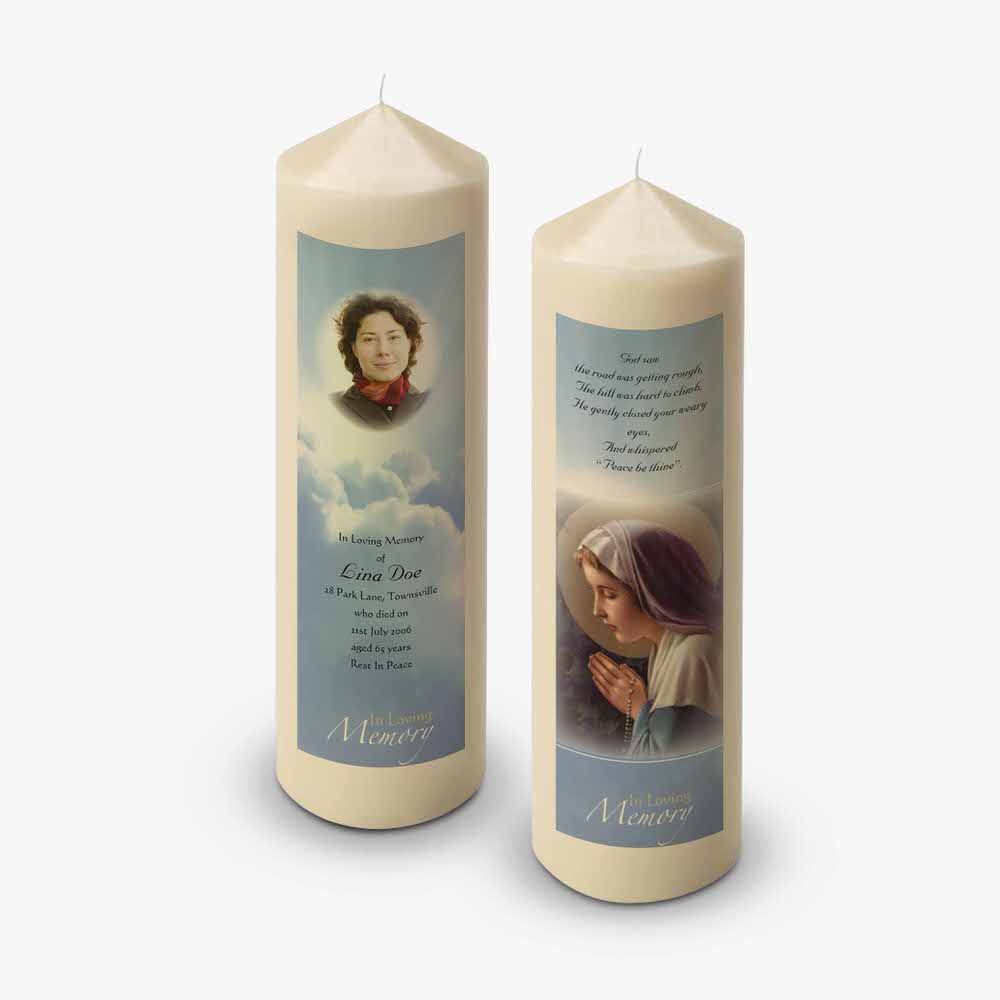 two candles with a picture of mary and jesus