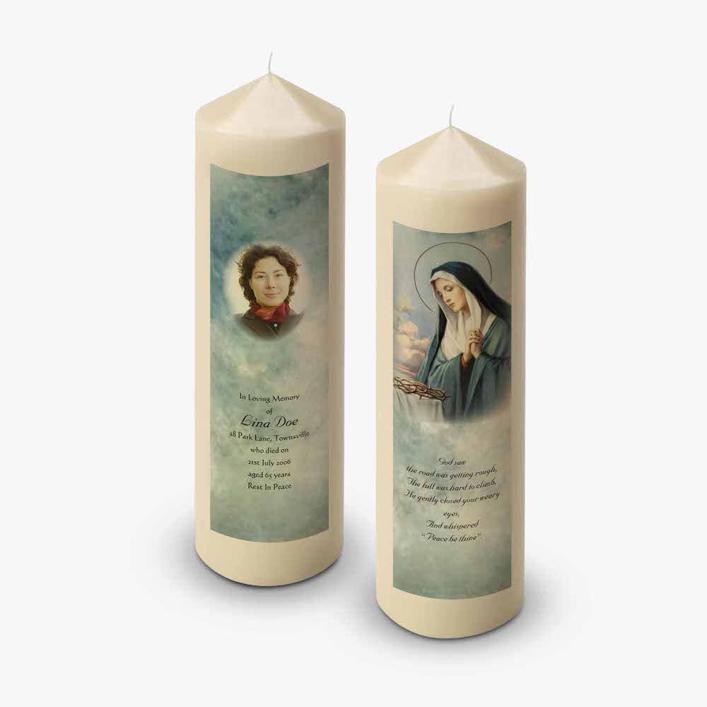 two candles with a picture of mary and jesus