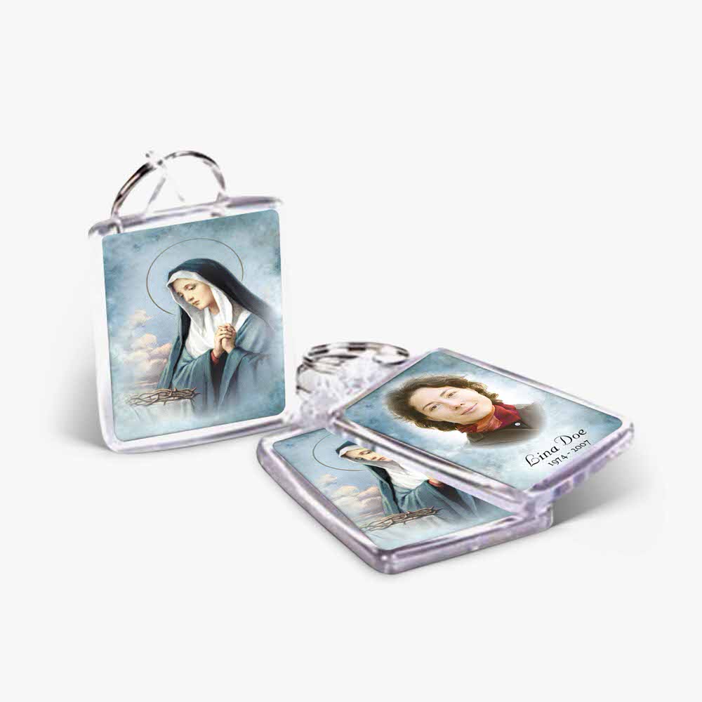 a keychain with a picture of mary and a picture of the pope