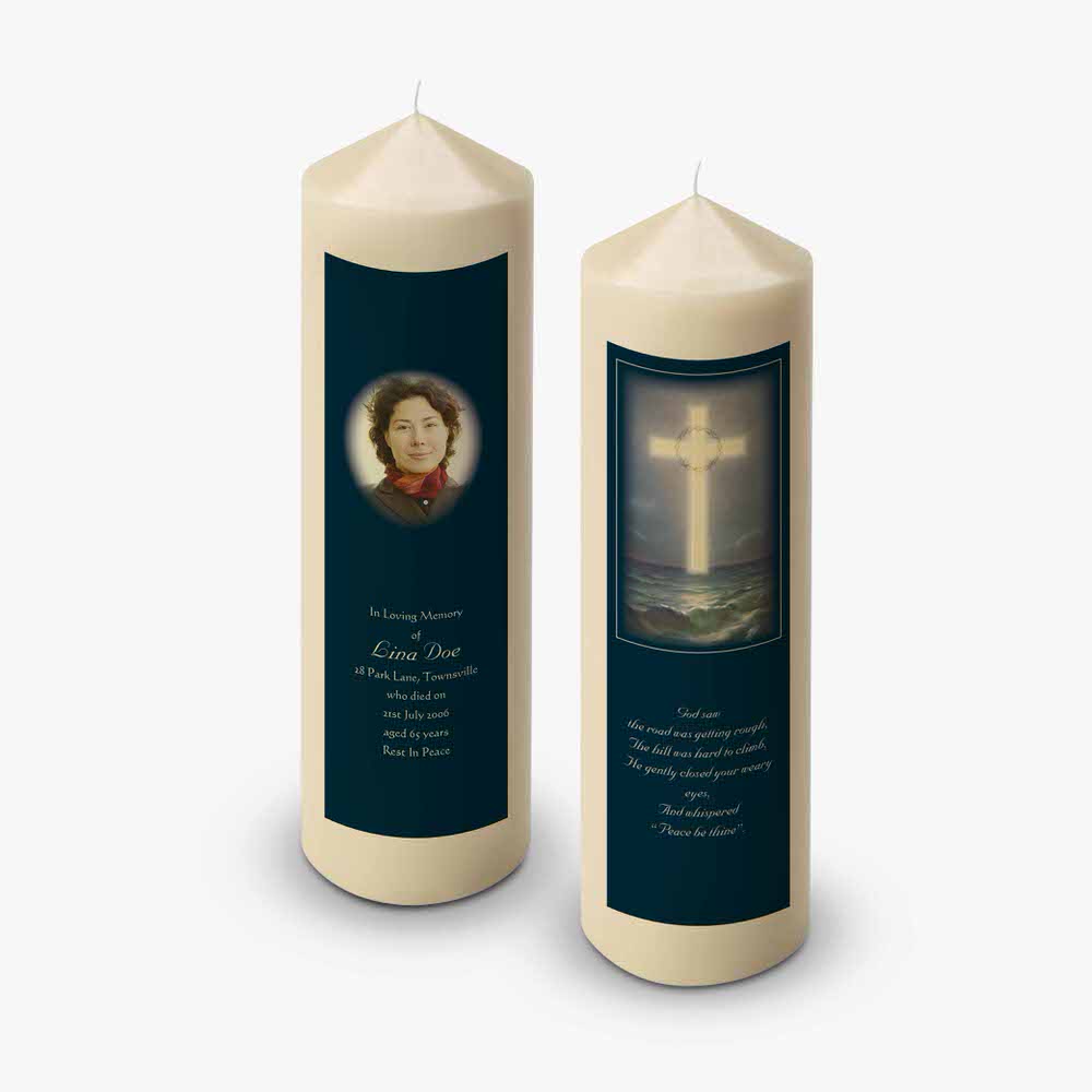 two candles with a picture of a cross on them
