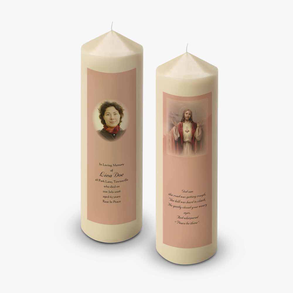 two candles with a picture of jesus on them