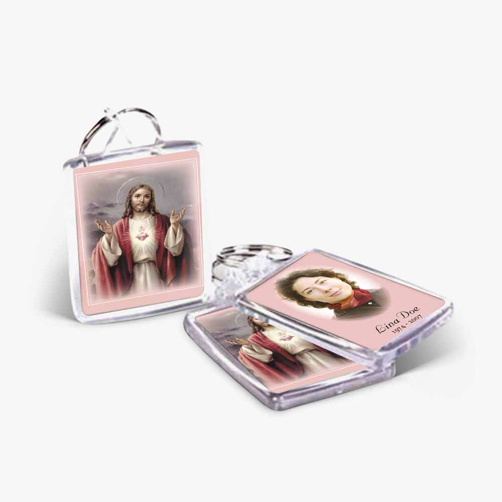a keychain with a picture of jesus and a pink background
