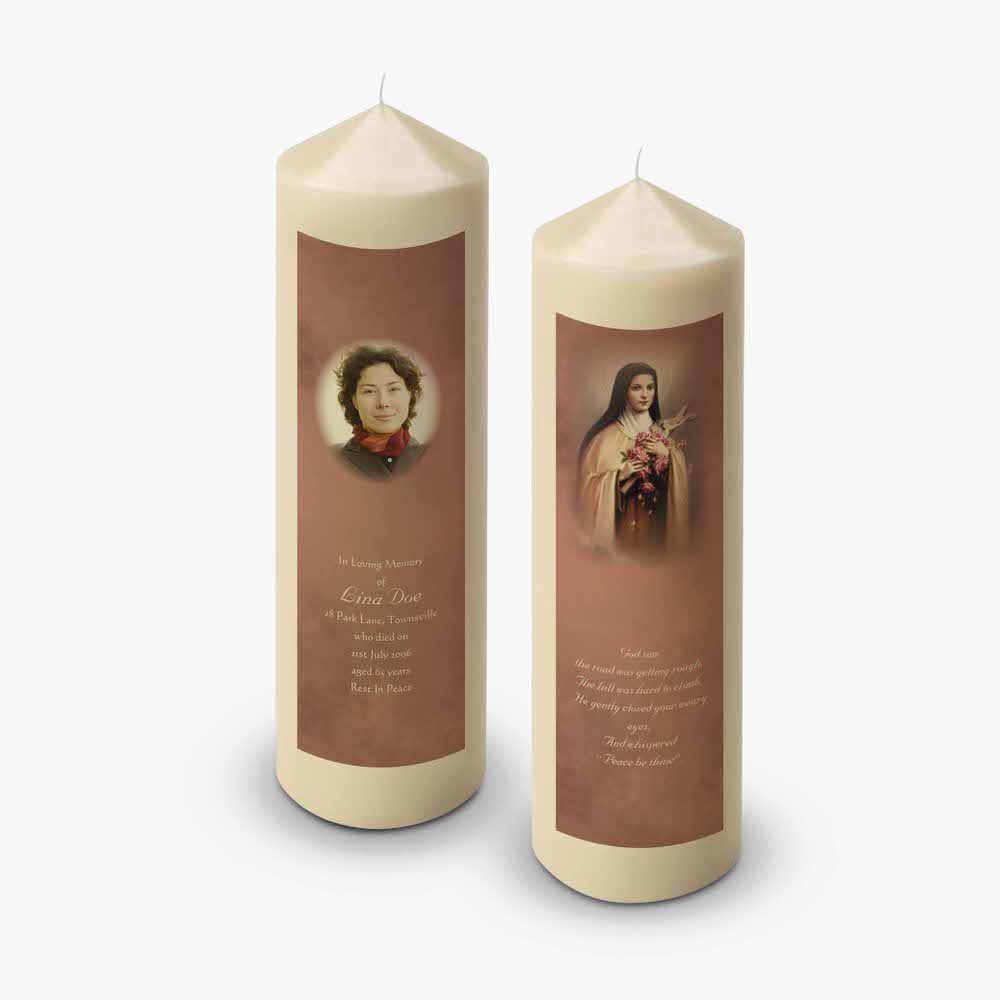 two candles with a picture of mary on them