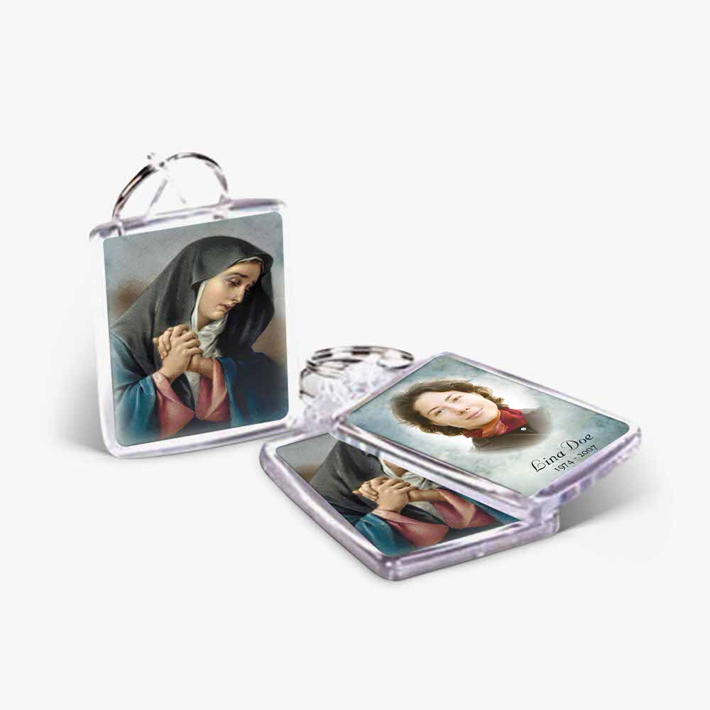 a key chain with a picture of mary and a picture of the person