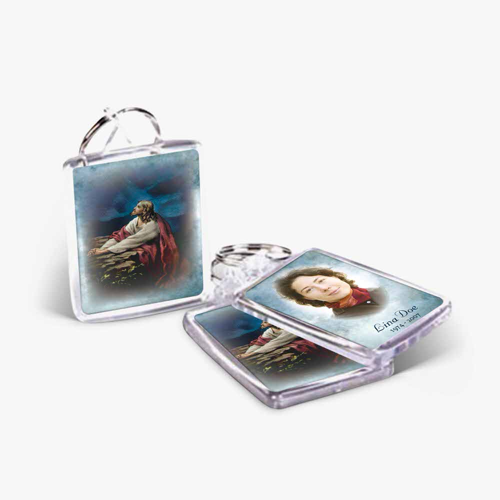 two key chains with pictures of jesus and a woman