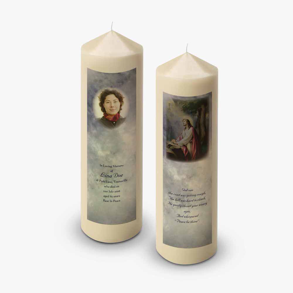 two candles with pictures of jesus and a woman