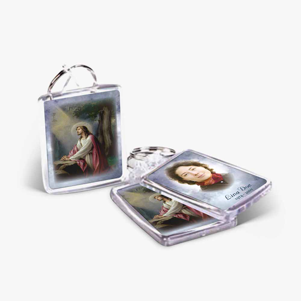 two key chains with pictures of jesus and a woman