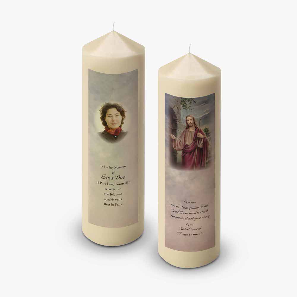 two candles with pictures of jesus and a woman