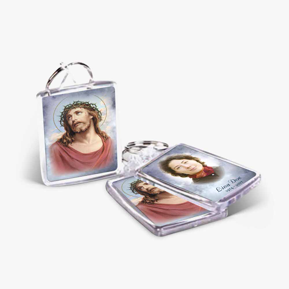 two key chains with pictures of jesus and a woman