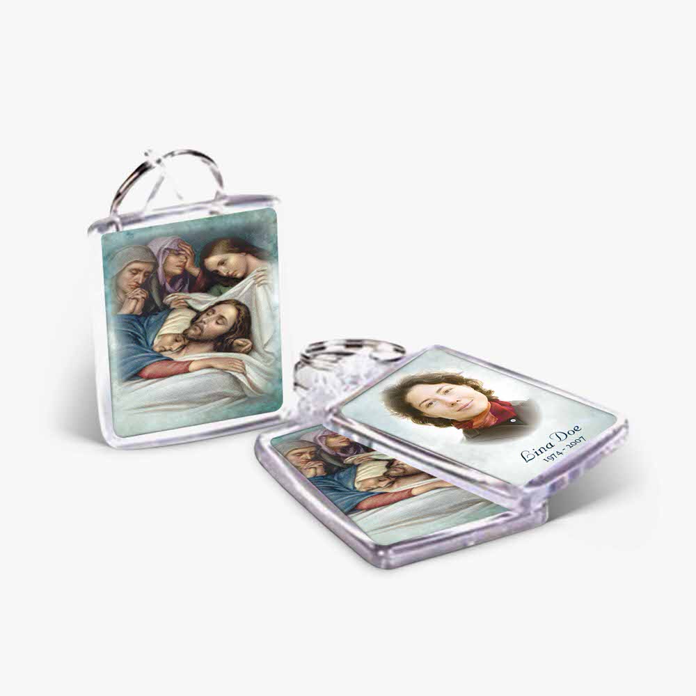 a key chain with a picture of jesus and a woman