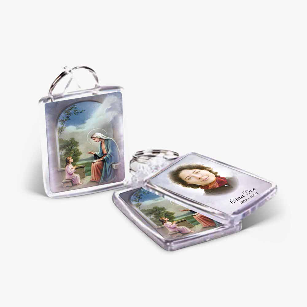 two key chains with pictures of the virgin mary