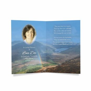 funeral card with rainbow and mountains