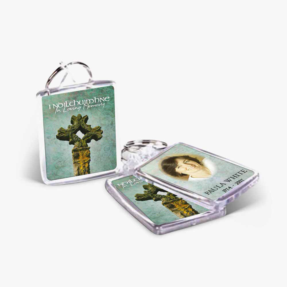 a keychain with a picture of a woman and a cross