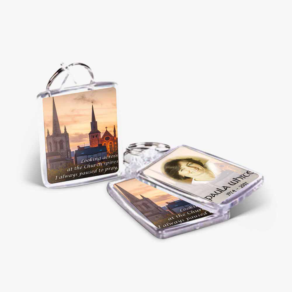 two key chains with a photo of a church and a city