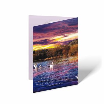 a greeting card with a picture of swans on the water