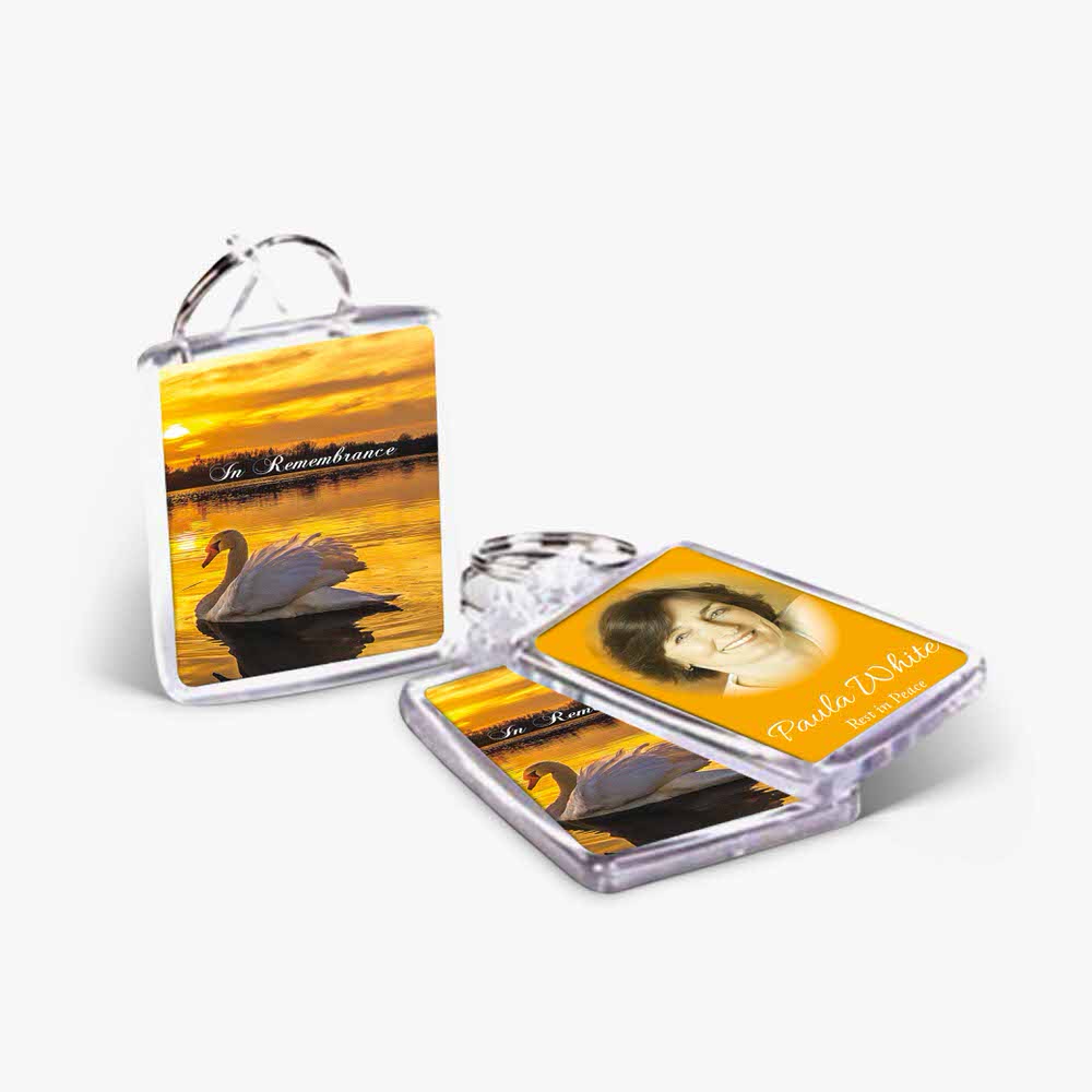 a keyring with a photo of a swan and a photo of a person