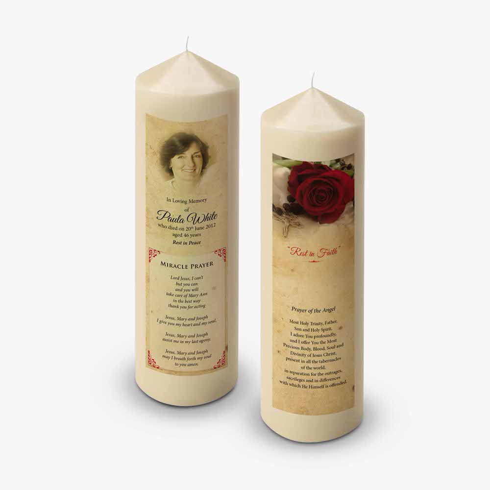 two candles with a rose on them