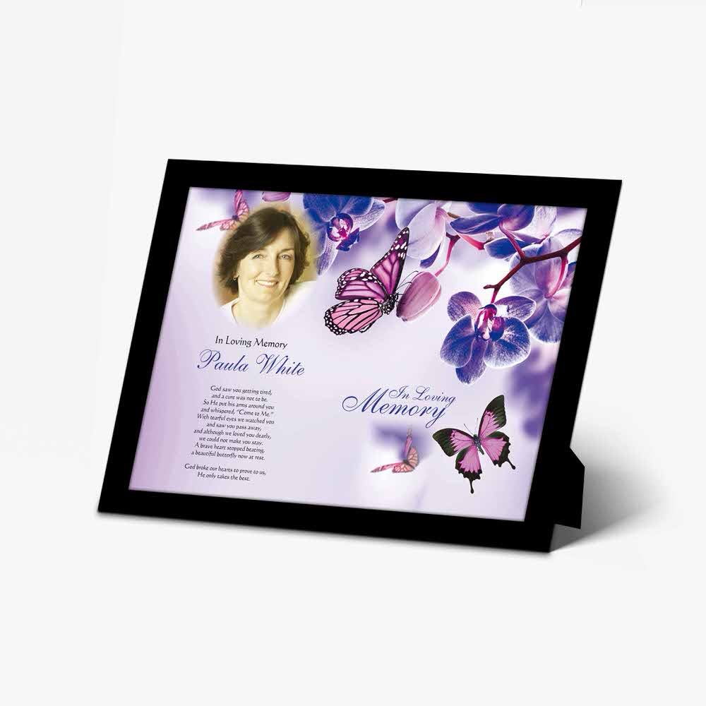 a memorial plaque with a butterfly and purple flowers